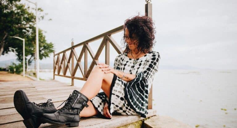 how to dress over 50 woman sitting on dock