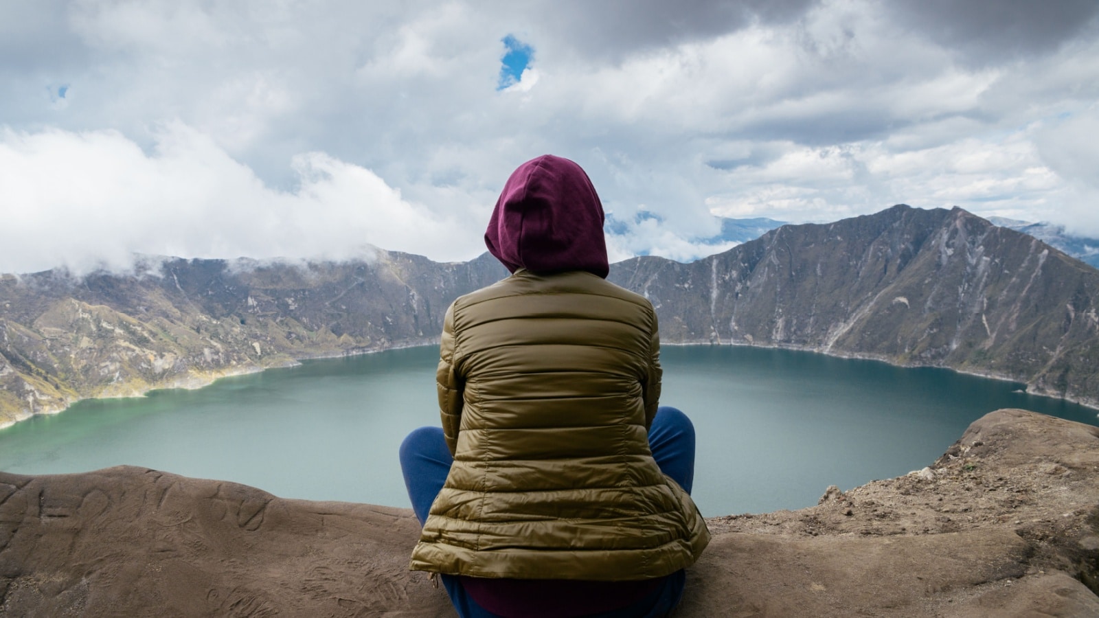 woman staring at lake alone
