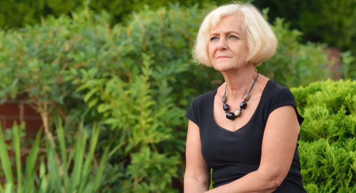 dealing with getting older, woman over 50 sitting alone
