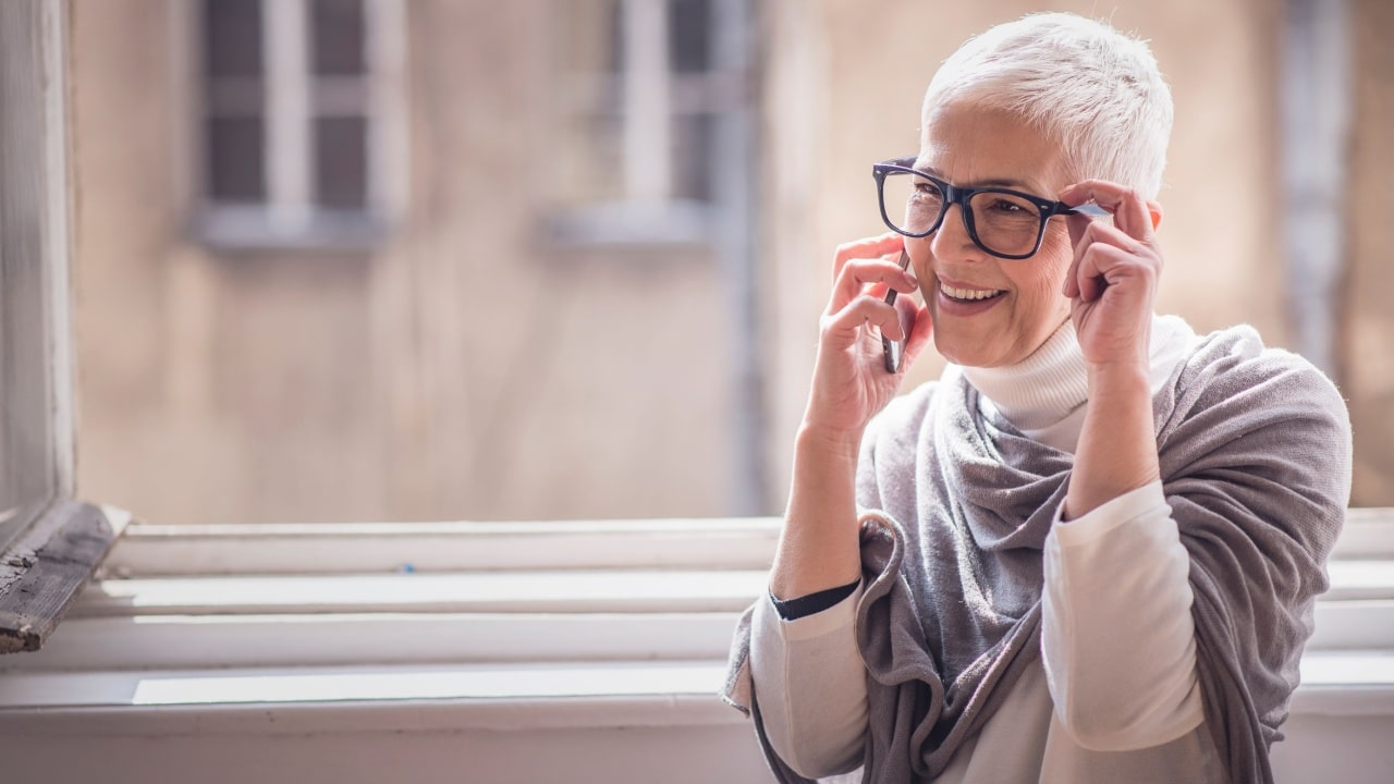 woman over 50 smiling on the phone