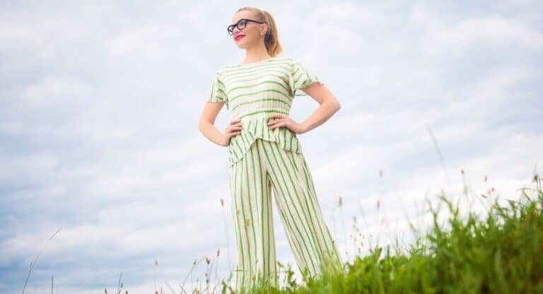 self-confidence quotes, happy woman standing on mountain